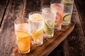 Vitamin water with fruits, refreshment cold drink on wooden background