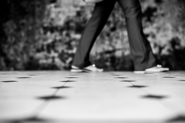 black and white photo of focus on floor tiles with old weathered