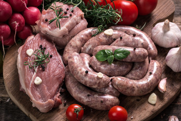 Fresh butcher cut meat assortment garnished with fresh rosemary on wooden table