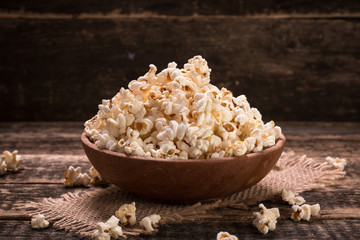 A bowl of popcorn on a wooden table