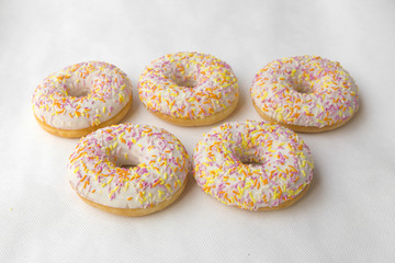 Tasty doughnut for tea. Donuts stacked slide. Food cakes delicious classic: fried doughnuts glazed with caramel. Nutritious dish that promotes obesity.