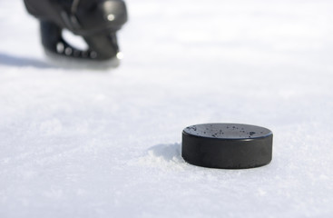 black hockey skate and a puck