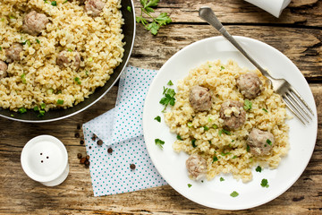 Bulgur with beef meatballs and spices in rustic style
