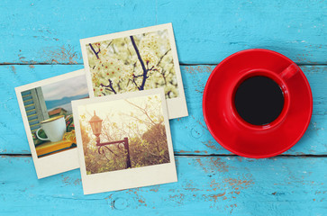 Fototapeta na wymiar top view of travel instant photographs next to cup of coffee