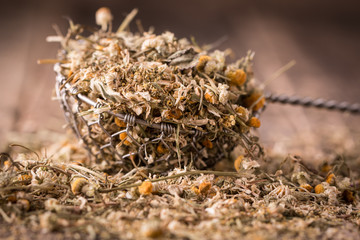 dried chamomile flowers, herbal tea raw  on wooden table