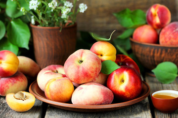 Naklejka na ściany i meble Ripe fruit peaches and apricots beautiful summer still life