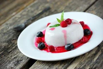Panna cotta with syrup and berries