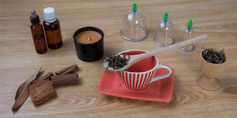 Acupuncture needles, herbs, cup, oil, TCM Traditional Chinese Medicine concept photo