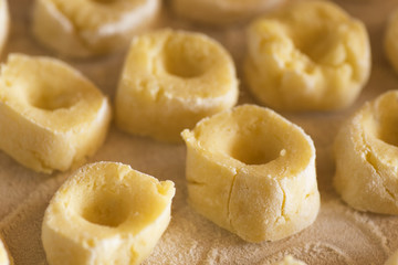 dumplings on a wooden board sprinkled with flour