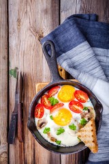 breakfast: fried eggs with tomatoes and mushrooms