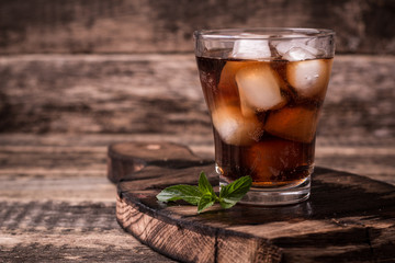 cold drink with ice on wooden vintage table
