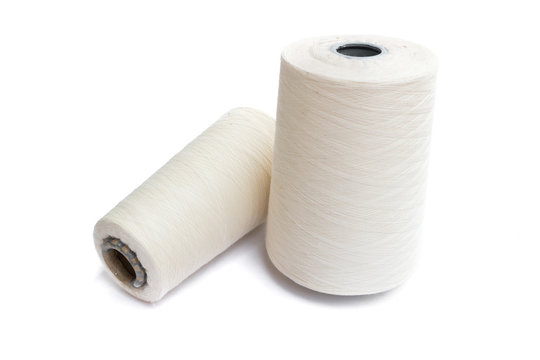 thread rolling, cotton ball thread together on white background