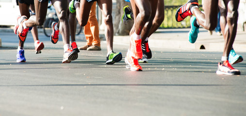 closeup of runners legs in a marathon