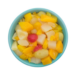 Top view of a bowl filled with fruit cocktail isolated on a white background.