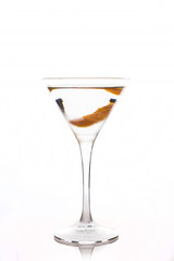 Cocktail with slice of orange zest in martini glass