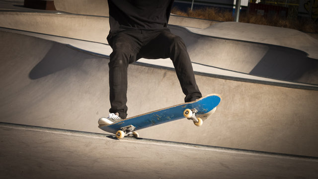Skateboarder grinding in skate-park