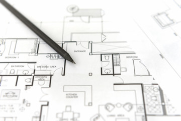 black pencil on architectural for construction drawings  with roll of blueprint