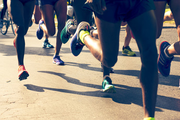 closeup of runners legs in a marathon - obrazy, fototapety, plakaty