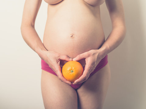 Pregnant woman with an orange