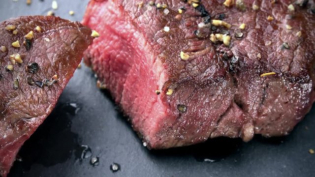 Beef Fillet (grilled; not loopable; 4K) on wooden background