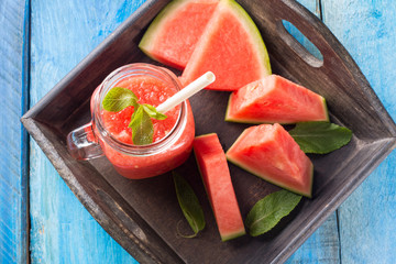 watermelon smoothie on blue wooden table