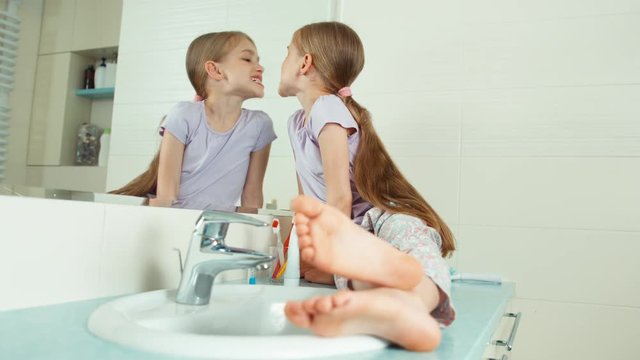 Girl viewing her teeth in the bathroom