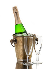 Champagne bottle in cooler and two champagne glasses