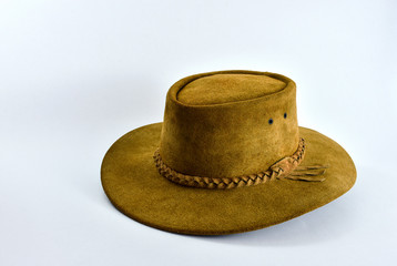 Yellow brown leather cowboy hat on white background