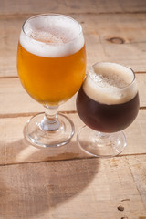 Dark and light beer on wood