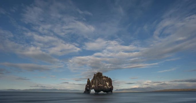 Sunset light on clouds above Hvitserkur rock, Iceland.