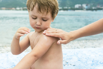 Protective cream for the child on beach