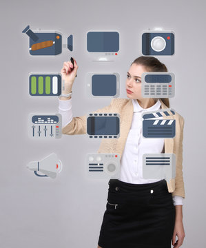 Woman pressing multimedia and entertainment icons on a virtual background