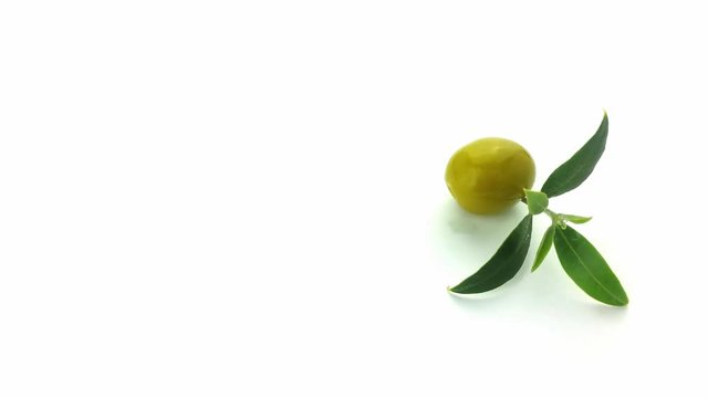 Olive with leaf turning on a white background, 4K UHD