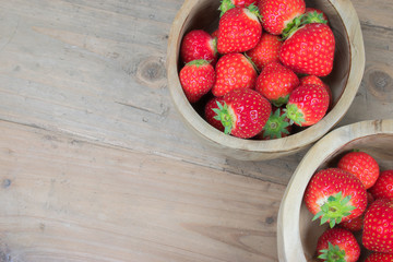 Top view of fresh strawberries in wooden bowls.