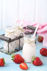 Strawberry yogurt in bottle on wooden table