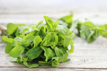 Fresh mint leafs on grey wooden table