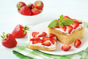 French toasts with cream cheese and strawberry on wooden table
