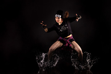 Fototapeta premium beautiful girl in the style of hip-hop jumping in aqua studio