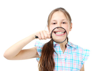 Young girl with magnifying glass on a white background