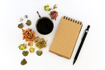 Cup of coffee, sketchbook, pencil and dried flowers. Flat lay, top view