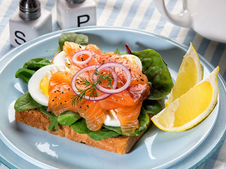 Fresh sandwich with gravlax salmon, egg and salad