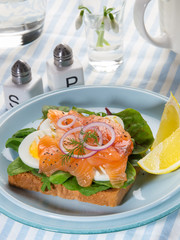 Fresh sandwich with gravlax salmon, egg and salad