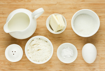 Fototapeta na wymiar Ingredients for pancakes - flour, eggs, salt, sugar, butter, milk