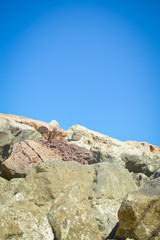 Stone rock seacoast, nature blue sky background outdoors, closeup