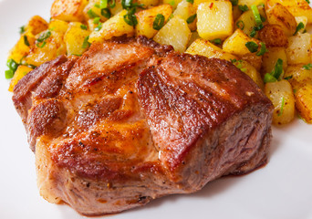 grilled meat fillet steak with fried potato in a plate on wooden table
