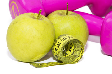 apple, dumbbells and tape measure