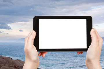 tourist photographs blue sunrise over Dead Sea