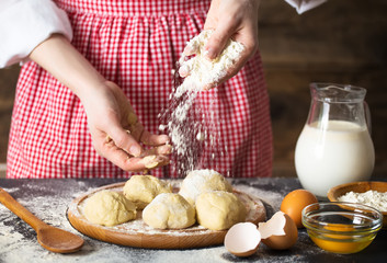 Making dough by female hands at bakery