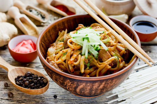 Japanese fried udon with pork in spicy ginger sauce