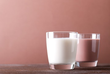 glass of white and chocolate milk on the table